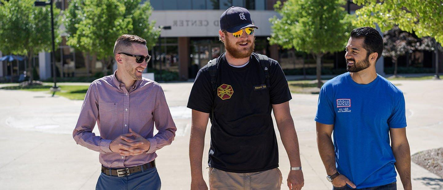 Three veteran students walk together outside the Oakland Center on O U's campus